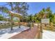 The Red Bug Slough Preserve entrance features an informative sign, a paved path, and a fenced area at 3330 Thornwood Rd # 3330, Sarasota, FL 34231