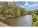 Scenic view of the pond surrounded by lush trees and greenery at 3330 Thornwood Rd # 3330, Sarasota, FL 34231