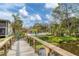 View of the community pool and pool house from the nearby wooden bridge at 3330 Thornwood Rd # 3330, Sarasota, FL 34231