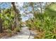 Gravel walking path leads to a wooden bridge with lush greenery on either side at 3330 Thornwood Rd # 3330, Sarasota, FL 34231