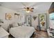 Bright bedroom with light-colored walls, hardwood floors, ceiling fan, and natural light from two windows at 3391 Tucson Rd, North Port, FL 34286