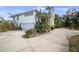 A winding driveway complements this white home and attached garage at 3391 Tucson Rd, North Port, FL 34286