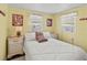 Cozy bedroom featuring a bed, two nightstands, and natural light from two windows at 4103 12Th Street E Ct, Ellenton, FL 34222