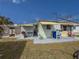 Back exterior showing patio area with grilling space, awnings, and easy access from inside home at 4103 12Th Street E Ct, Ellenton, FL 34222