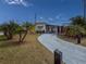 Charming single-story home with a well-manicured lawn, mature palms and long driveway at 4103 12Th Street E Ct, Ellenton, FL 34222