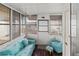 Comfortable Florida room with wood paneled walls and matching blue furniture at 4103 12Th Street E Ct, Ellenton, FL 34222