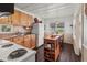 Bright kitchen with wood cabinets, an island on wheels, and a white refrigerator at 4103 12Th Street E Ct, Ellenton, FL 34222