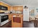 Well-equipped kitchen featuring wood cabinets, black appliances, and a mobile island at 4103 12Th Street E Ct, Ellenton, FL 34222