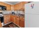 Bright kitchen with wood cabinets, stone countertops, and stainless steel appliances at 4103 12Th Street E Ct, Ellenton, FL 34222