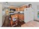 Functional kitchen with wood cabinets, black appliances, and a mobile island at 4103 12Th Street E Ct, Ellenton, FL 34222