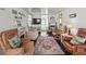 Cozy living room with hardwood floors, white walls, and comfortable seating with vintage-style furniture at 4103 12Th Street E Ct, Ellenton, FL 34222