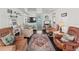 Cozy living room with hardwood floors, white walls, and comfortable seating with vintage-style furniture at 4103 12Th Street E Ct, Ellenton, FL 34222