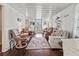 Spacious living room showcasing hardwood floors, white walls, and comfortable seating, perfect for relaxation and entertaining at 4103 12Th Street E Ct, Ellenton, FL 34222