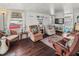 Inviting living room with wood floors, white walls, and a charming window and curtains allowing plenty of natural light at 4103 12Th Street E Ct, Ellenton, FL 34222