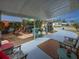 Spacious outdoor patio perfect for entertaining with bar, seating, and lush landscaping at 4103 12Th Street E Ct, Ellenton, FL 34222