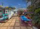 Cozy outdoor lounge area with tent, seating, and tropical landscaping at 4103 12Th Street E Ct, Ellenton, FL 34222