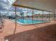 Community swimming pool with ample seating and shade at Tidevue Estates at 4103 12Th Street E Ct, Ellenton, FL 34222