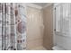 Clean shower with a decorative curtain and a window with shutter-style blinds at 4103 12Th Street E Ct, Ellenton, FL 34222