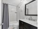 Bathroom featuring a black vanity, white marble countertop, and a shower with a curtain at 4104 35Th W Ave, Bradenton, FL 34205