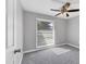Carpeted bedroom featuring a window with blinds and a modern ceiling fan at 4104 35Th W Ave, Bradenton, FL 34205