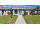 Inviting villa featuring a well-maintained lawn and walkway leading to the front door at 4104 35Th W Ave, Bradenton, FL 34205