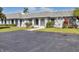 Charming villa with well-manicured landscaping and a spacious driveway on a sunny day at 4104 35Th W Ave, Bradenton, FL 34205