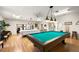 Spacious game room featuring pool and poker tables, along with wood laminate floors at 4104 35Th W Ave, Bradenton, FL 34205