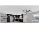 Modern kitchen featuring stainless steel appliances and dark cabinetry with tile backsplash at 4104 35Th W Ave, Bradenton, FL 34205