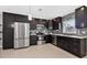 Modern kitchen boasts stainless steel appliances, dark cabinetry, and stylish backsplash at 4104 35Th W Ave, Bradenton, FL 34205