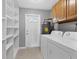 Laundry room with a washer, dryer, storage shelves and an exterior door at 4104 35Th W Ave, Bradenton, FL 34205