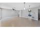 Open living room with light wood floors, ceiling fan, and modern lighting fixtures at 4104 35Th W Ave, Bradenton, FL 34205