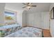 The well-lit bedroom showcases two twin beds, hardwood floors and ample closet space at 4117 Roberts Point Cir, Sarasota, FL 34242