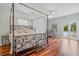 Spacious bedroom with hardwood floors and a decorative four-poster bed at 4117 Roberts Point Cir, Sarasota, FL 34242