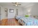 This bedroom offers twin beds, hardwood floors and a side table with a colorful green drawer at 4117 Roberts Point Cir, Sarasota, FL 34242