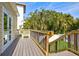 Inviting backyard deck features wooden railings, stairs, and entry door at 4117 Roberts Point Cir, Sarasota, FL 34242