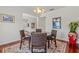 Inviting dining room featuring a round table, elegant lighting, and hardwood floors for stylish and comfortable dining at 4117 Roberts Point Cir, Sarasota, FL 34242
