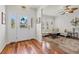 Inviting foyer with hardwood floors and a decorative window leading into the beautifully furnished living room area at 4117 Roberts Point Cir, Sarasota, FL 34242