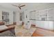 Living room with hardwood floors, built in cabinets, and view of the kitchen at 4117 Roberts Point Cir, Sarasota, FL 34242