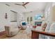 Spacious living room with plantation shutters, hardwood floors, and access to an outdoor patio at 4117 Roberts Point Cir, Sarasota, FL 34242