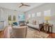 Spacious living room with plantation shutters, hardwood floors, and access to an outdoor patio at 4117 Roberts Point Cir, Sarasota, FL 34242