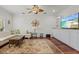 Bright living room with hardwood floors, a ceiling fan, and elegant decor, creating a comfortable and stylish space at 4117 Roberts Point Cir, Sarasota, FL 34242