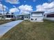 Charming single Gathering home with carport and manicured lawn in a friendly neighborhood with beautiful blue skies at 415 Dublin Ave, Bradenton, FL 34207