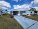Charming manufactured home featuring a covered parking area and well-maintained landscaping at 415 Dublin Ave, Bradenton, FL 34207