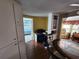 View of the kitchen with wood floors, leading to a bedroom and the living room at 415 Dublin Ave, Bradenton, FL 34207