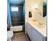 This bathroom includes a shower/tub combo, toilet, sink, and cabinet at 415 Oakwood E Blvd, Sarasota, FL 34237