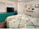 Bright bedroom features a double bed, closet, and dresser at 415 Oakwood E Blvd, Sarasota, FL 34237