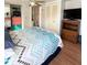 This bedroom includes an ensuite bathroom, closet, ceiling fan, and TV at 415 Oakwood E Blvd, Sarasota, FL 34237