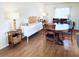 Bright dining room with a wooden table, seating for six, and stylish lamps at 415 Oakwood E Blvd, Sarasota, FL 34237