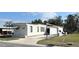 Charming home with a large driveway, covered parking, and well maintained lawn at 415 Oakwood E Blvd, Sarasota, FL 34237