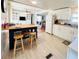 Well-lit kitchen featuring white cabinetry and an island with seating at 415 Oakwood E Blvd, Sarasota, FL 34237